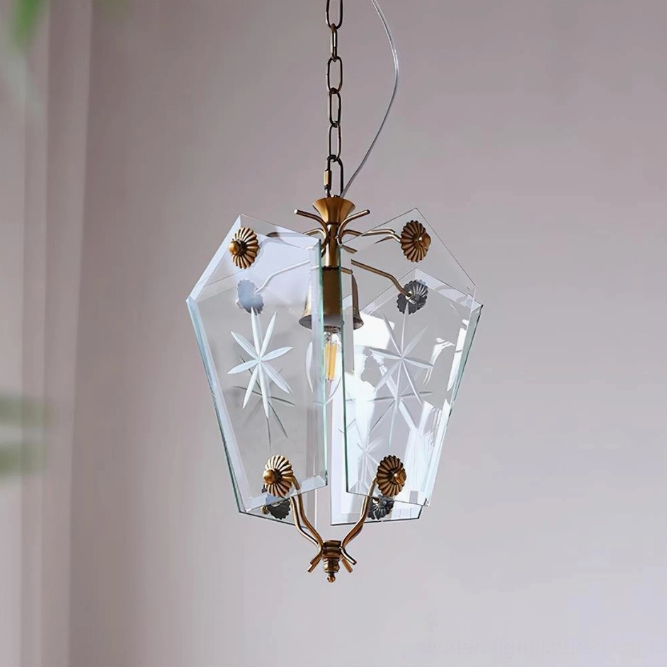 Vintage brass pendant lamp with star-etched clear glass shade angled indoor view with curtains