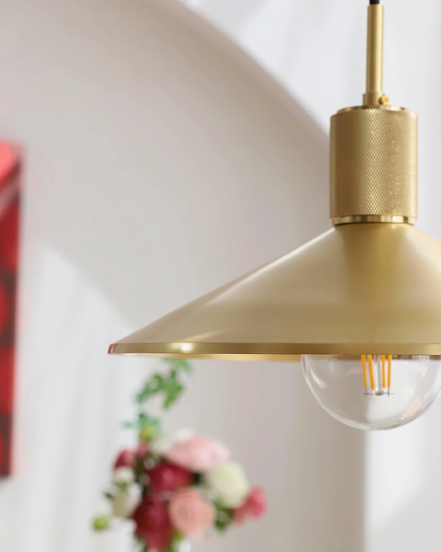 Vintage-inspired brass pendant light showing exposed bulb detail and lustrous metallic finish