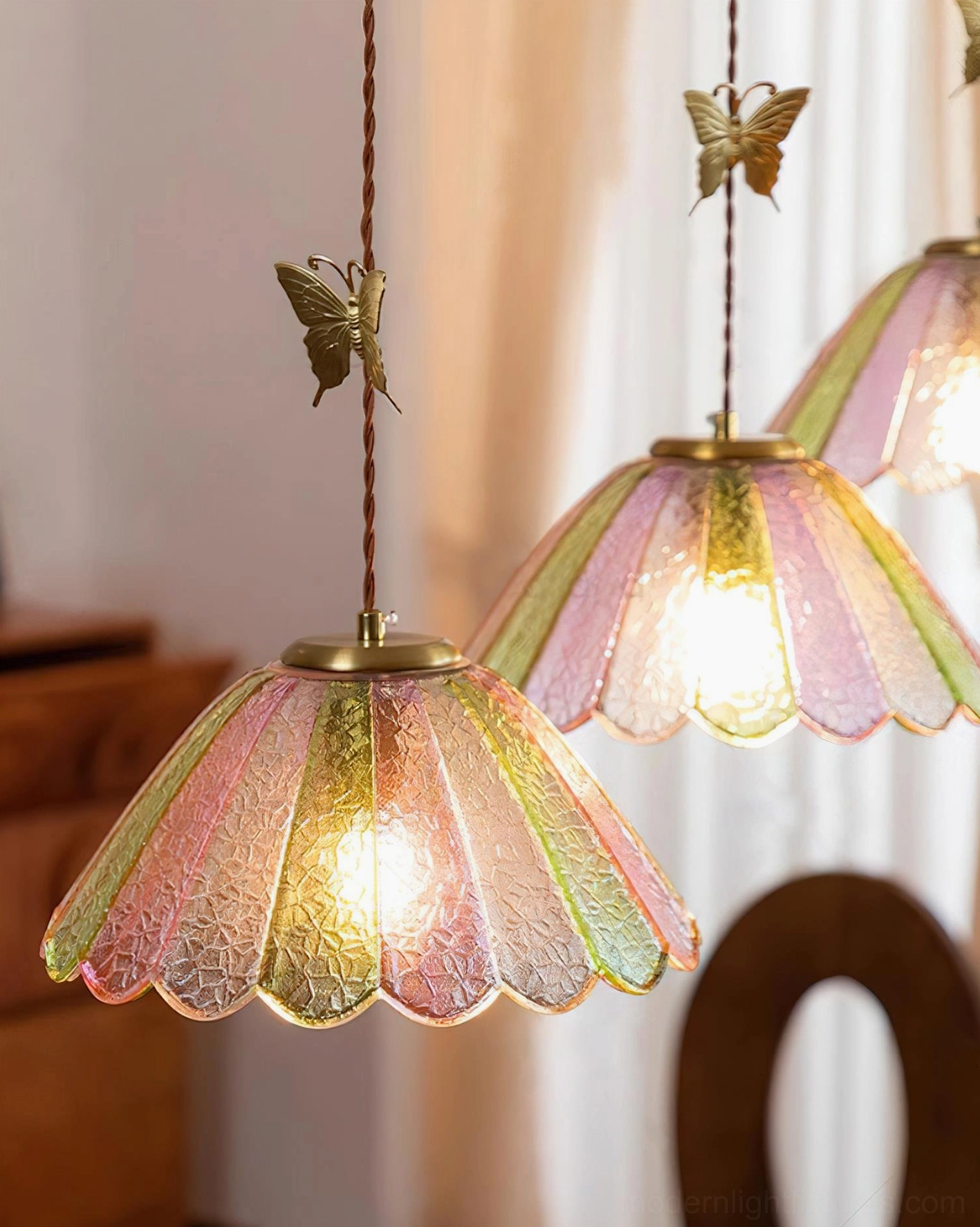 Vintage butterfly pendant light showing scalloped glass shade gradient from pink to green