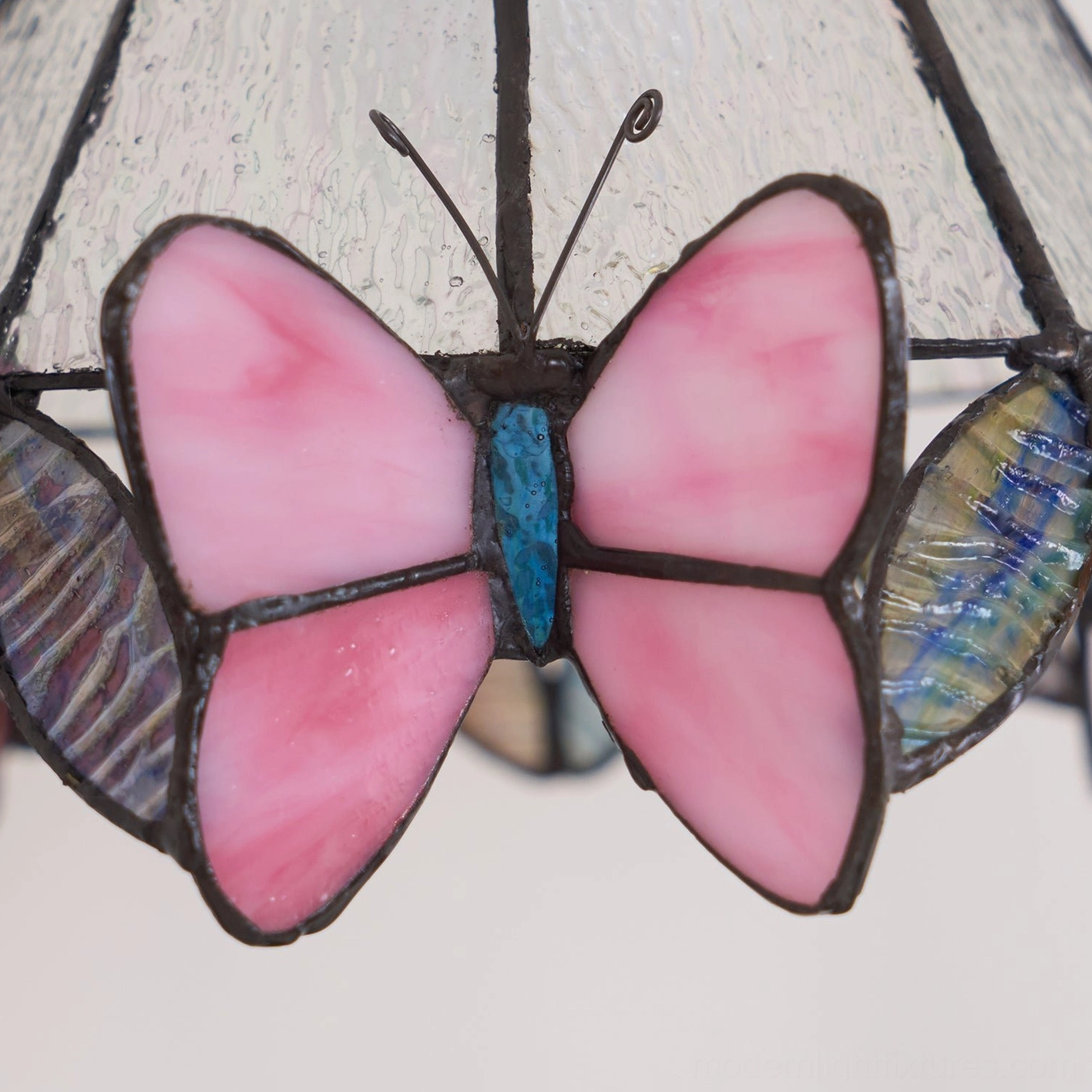 Vintage-inspired stained glass butterfly table lamp in classic home décor setting