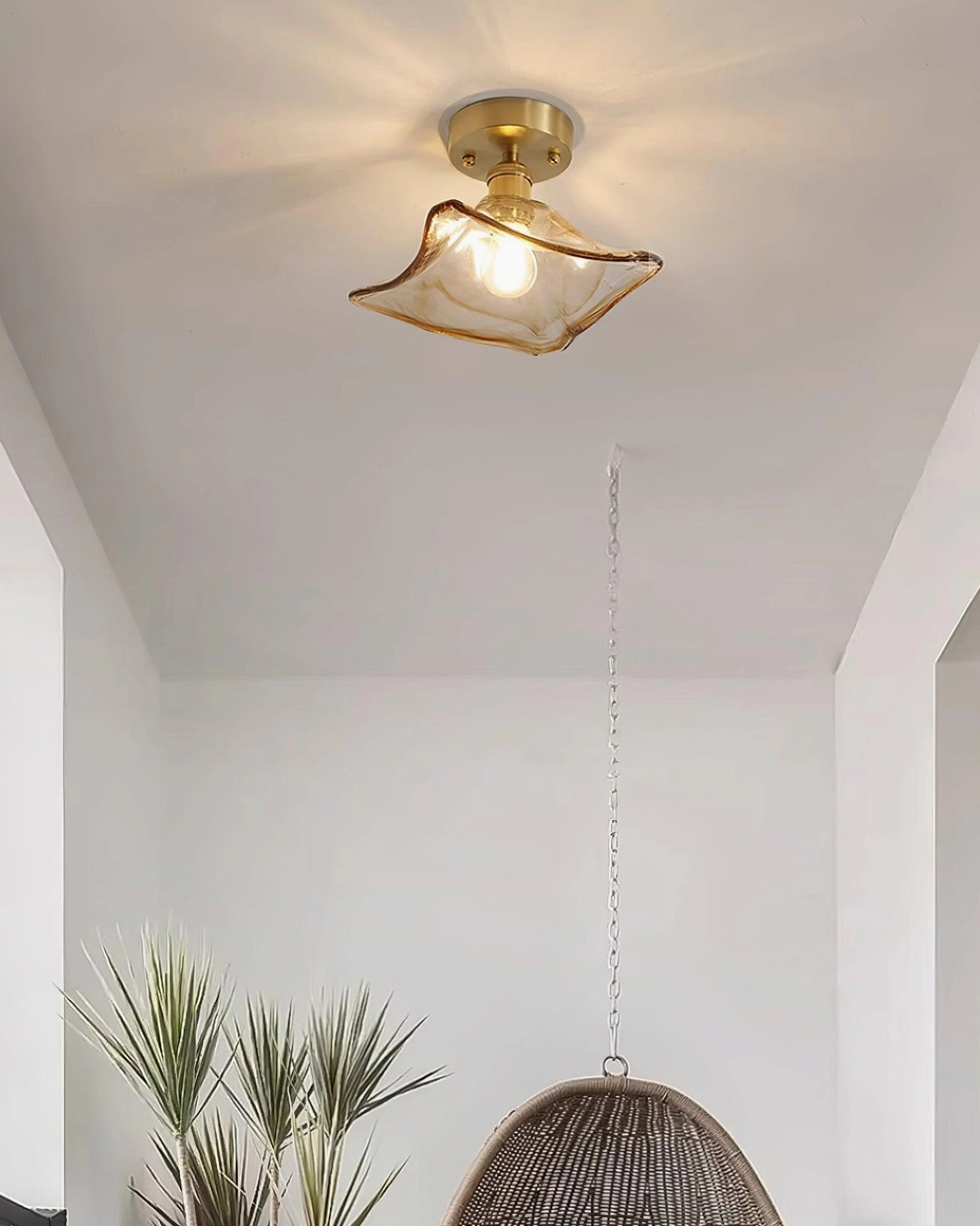 Vintage amber glass semi-flush ceiling light fixture detail showing brass hardware and glass shade construction