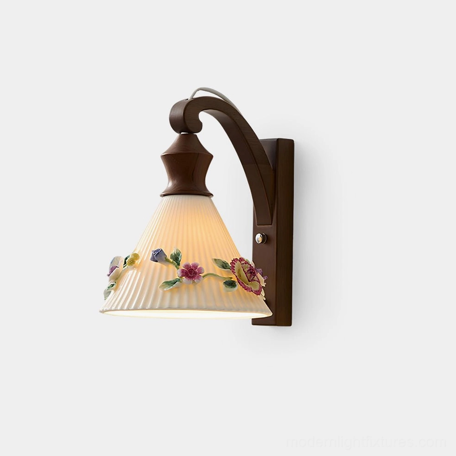 Vintage floral wall sconce with hand-sculpted ceramic shade and wooden bracket, frontal view on white background