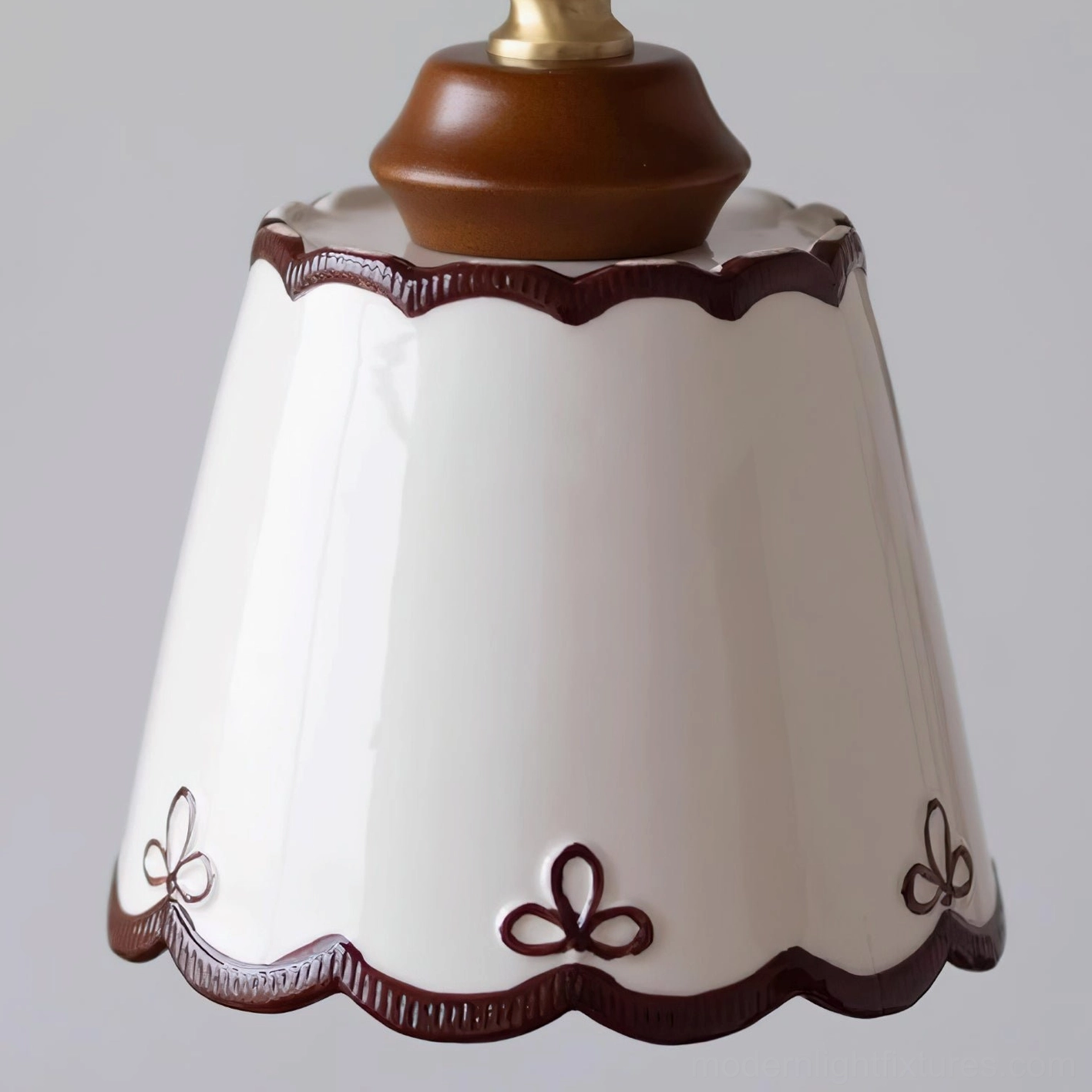 Vintage ceramic pendant lamp with glossy white shade and warm bronze accents in contemporary home setting