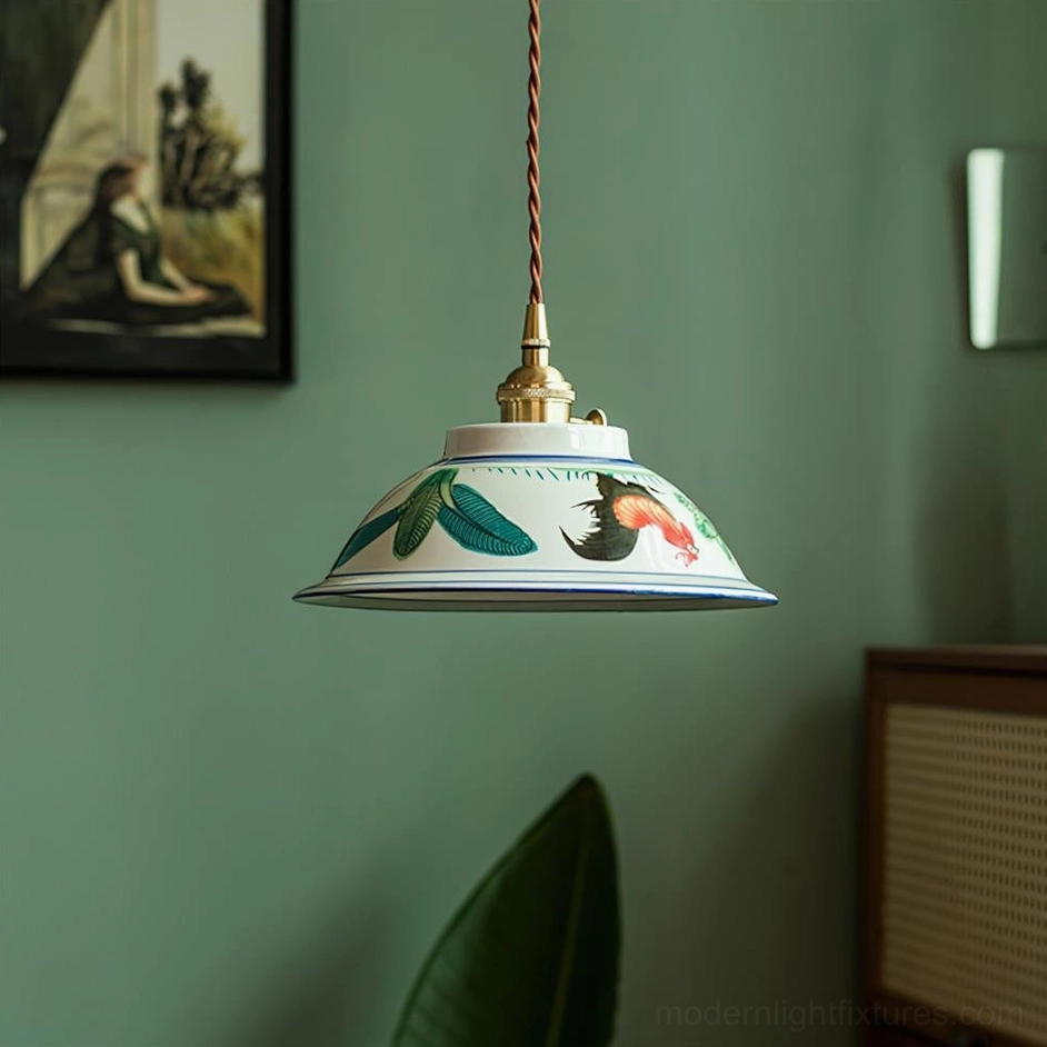 Vintage-inspired ceramic pendant lamp with hand-painted floral design and brass hardware, hanging against neutral wall background