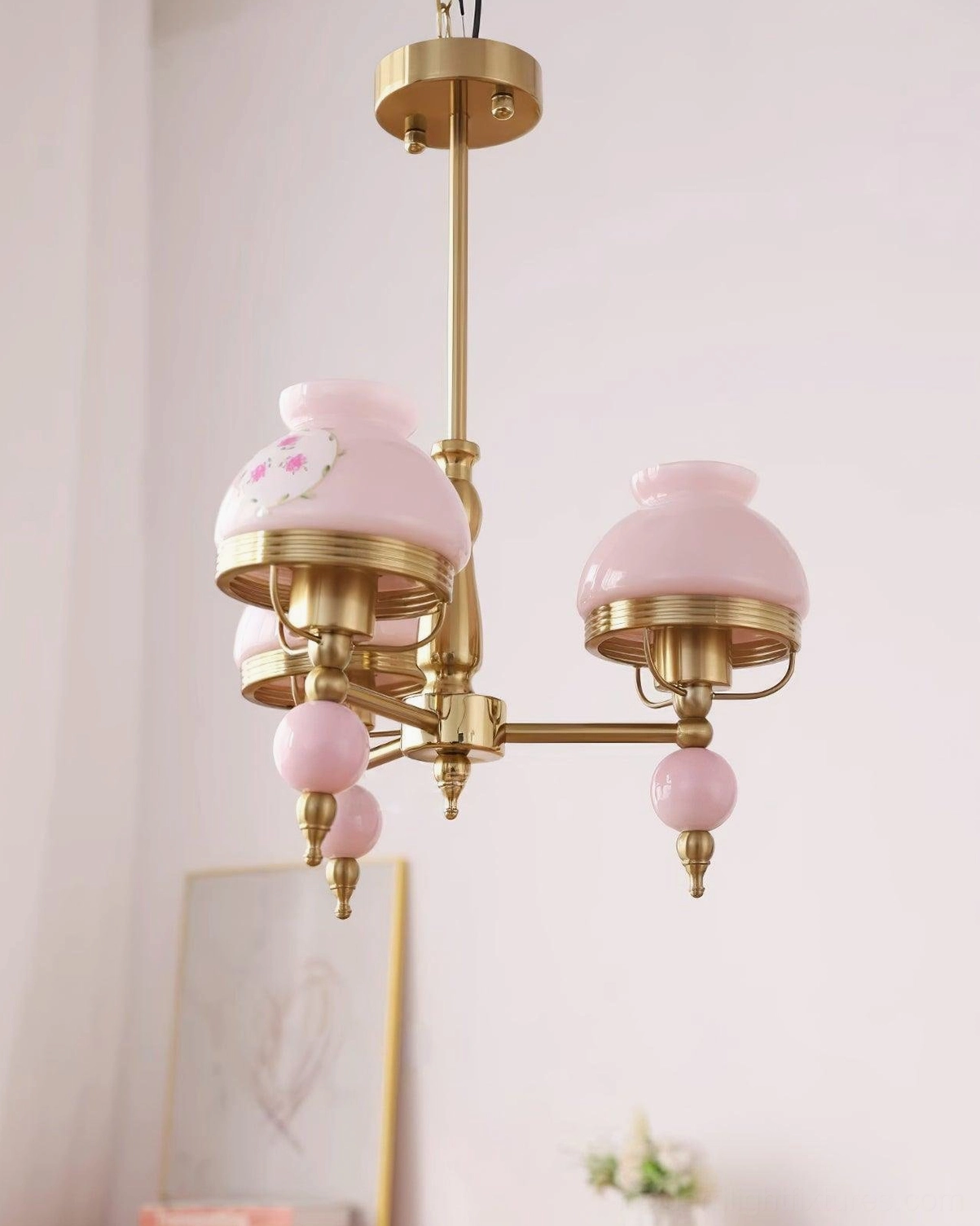 3-head vintage glass chandelier suspended in home interior with warm ambient lighting