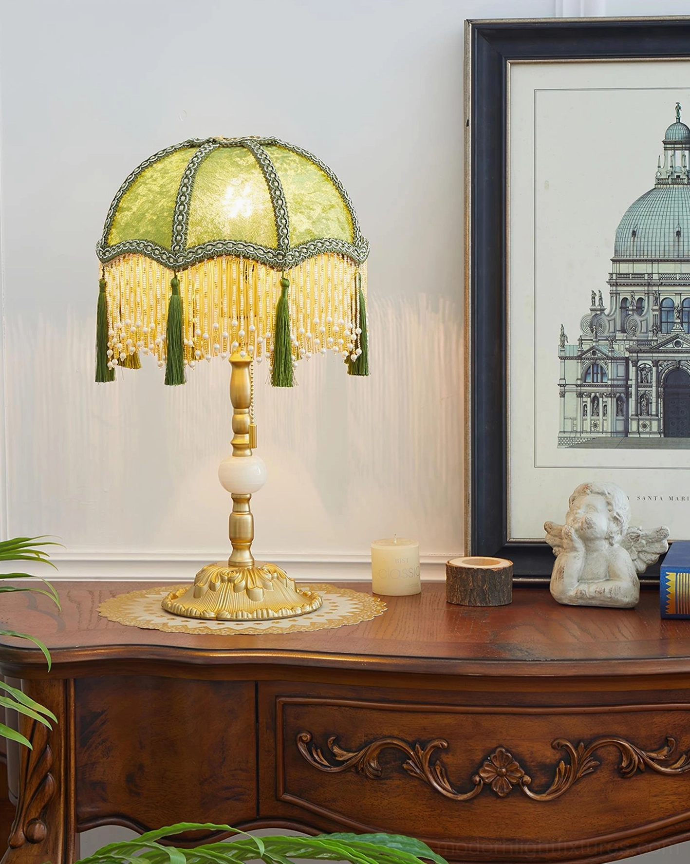 Lit emerald green vintage table lamp on wooden side table with luxury home decor styling