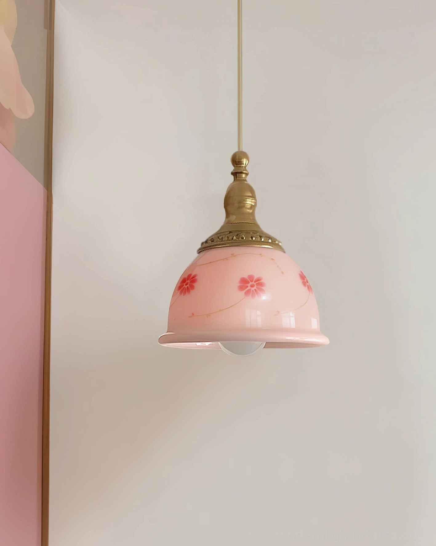 Side view of vintage style ceramic floral pendant light with brass fixtures and delicate red flower prints
