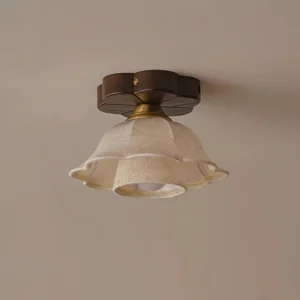 Side profile of vintage floral ceiling fixture showing fabric shade detail and exposed brass hardware connector with warm golden finish