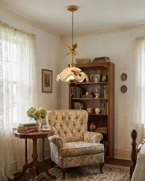 Vintage floral pendant lamp hanging above tufted armchair in classic living room setting