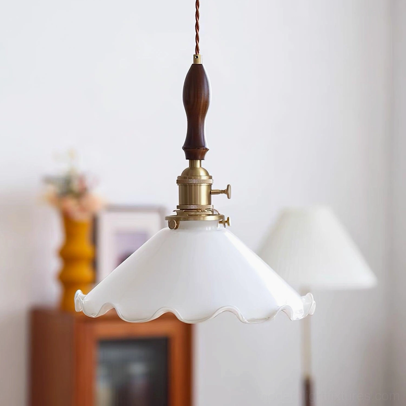 Vintage flower pendant lamp with frilled white glass shade and wood-brass fixture, three-quarter angle view
