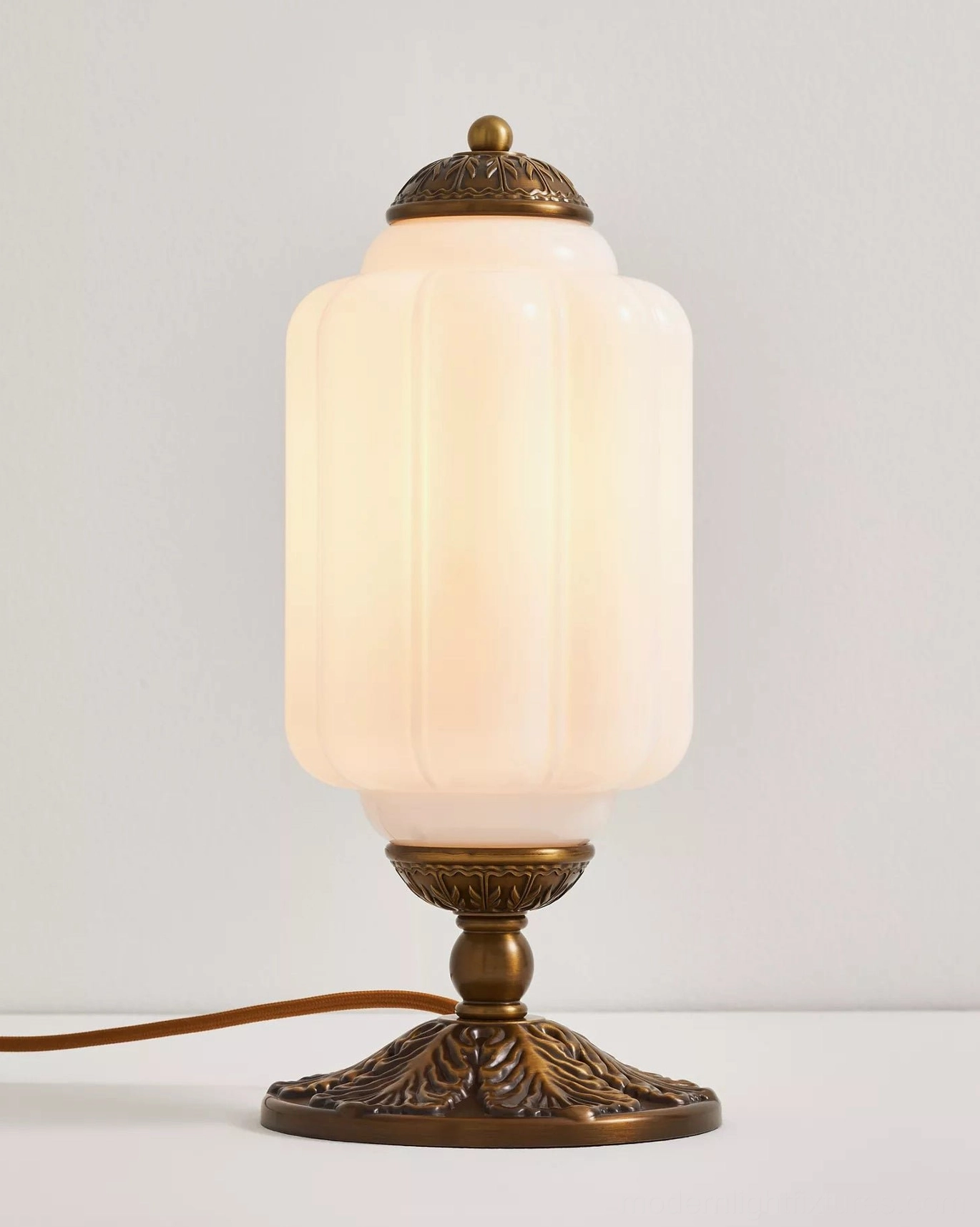 Vintage decorative fluted glass table lamp with bronze hardware and warm ambient light glow
