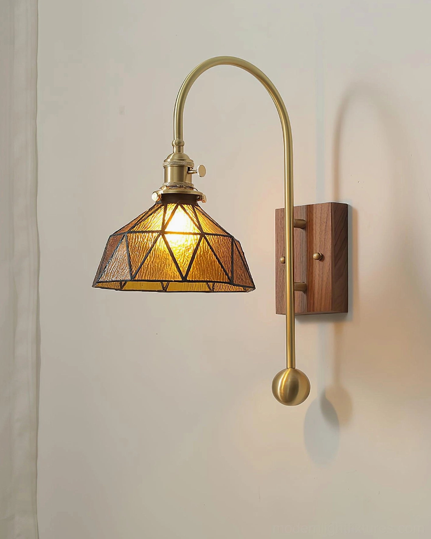 Vintage stained glass wall sconce with geometric amber glass shade and solid brass hardware