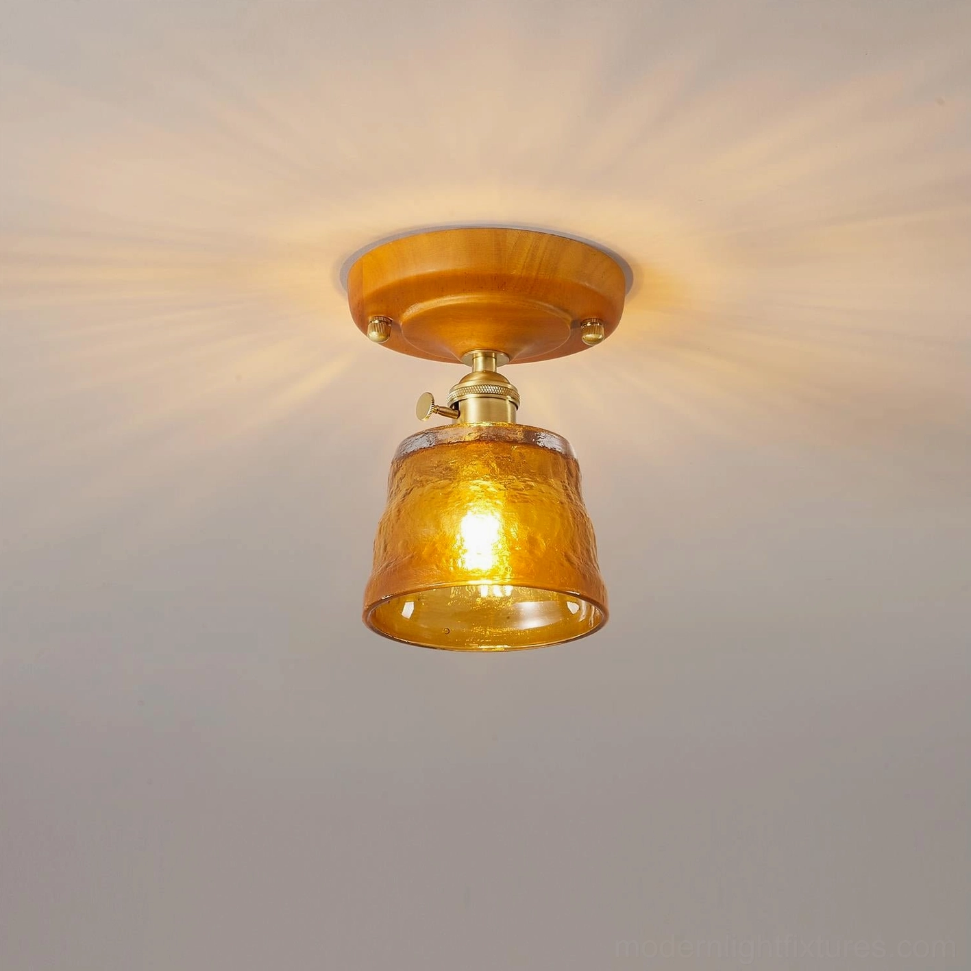 Vintage glass ceiling light fixture architectural detail showing glass-to-brass connection