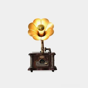 Vintage gramophone table lamp with retro wood body and golden flower-shaped lampshade on white background - front view