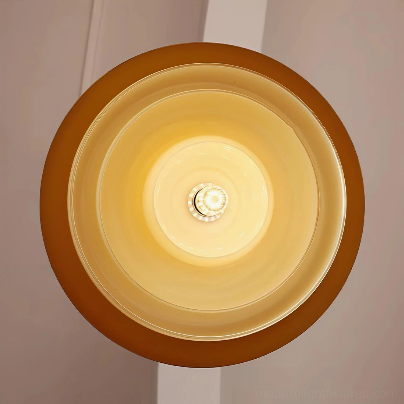 Vintage-inspired brass pendant light with frosted glass dome, warm glow demonstration in residential space
