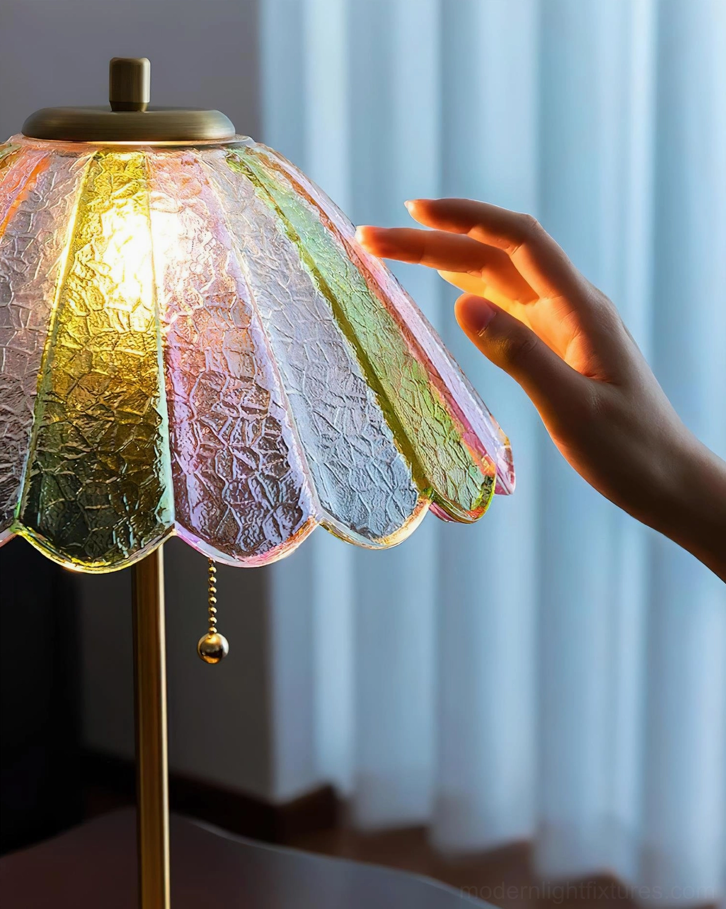 Close-up detail of vintage table lamp ripple textured gradient glass shade with hand interaction