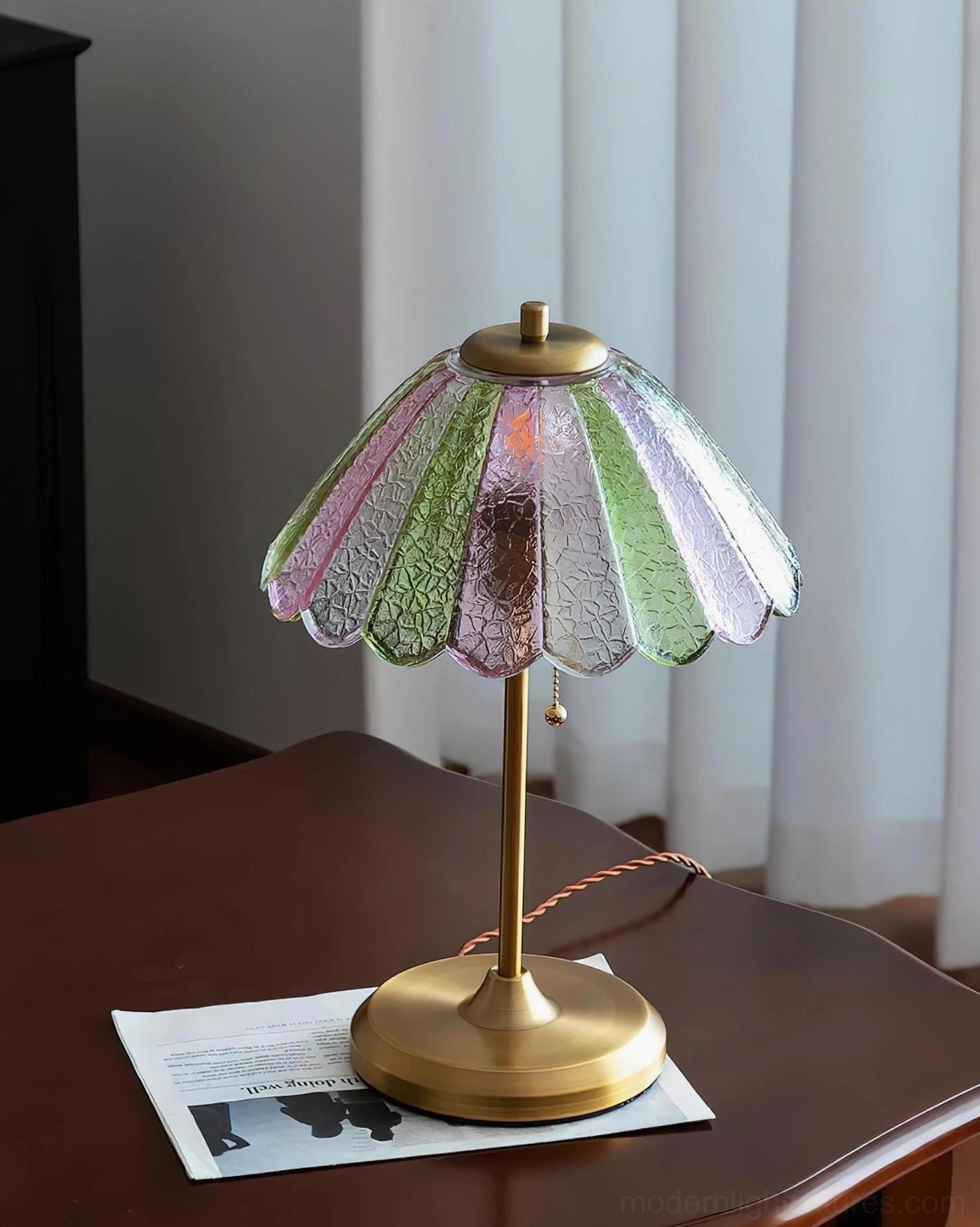 Vintage table lamp with multi-color gradient glass shade paired with home décor items on side table