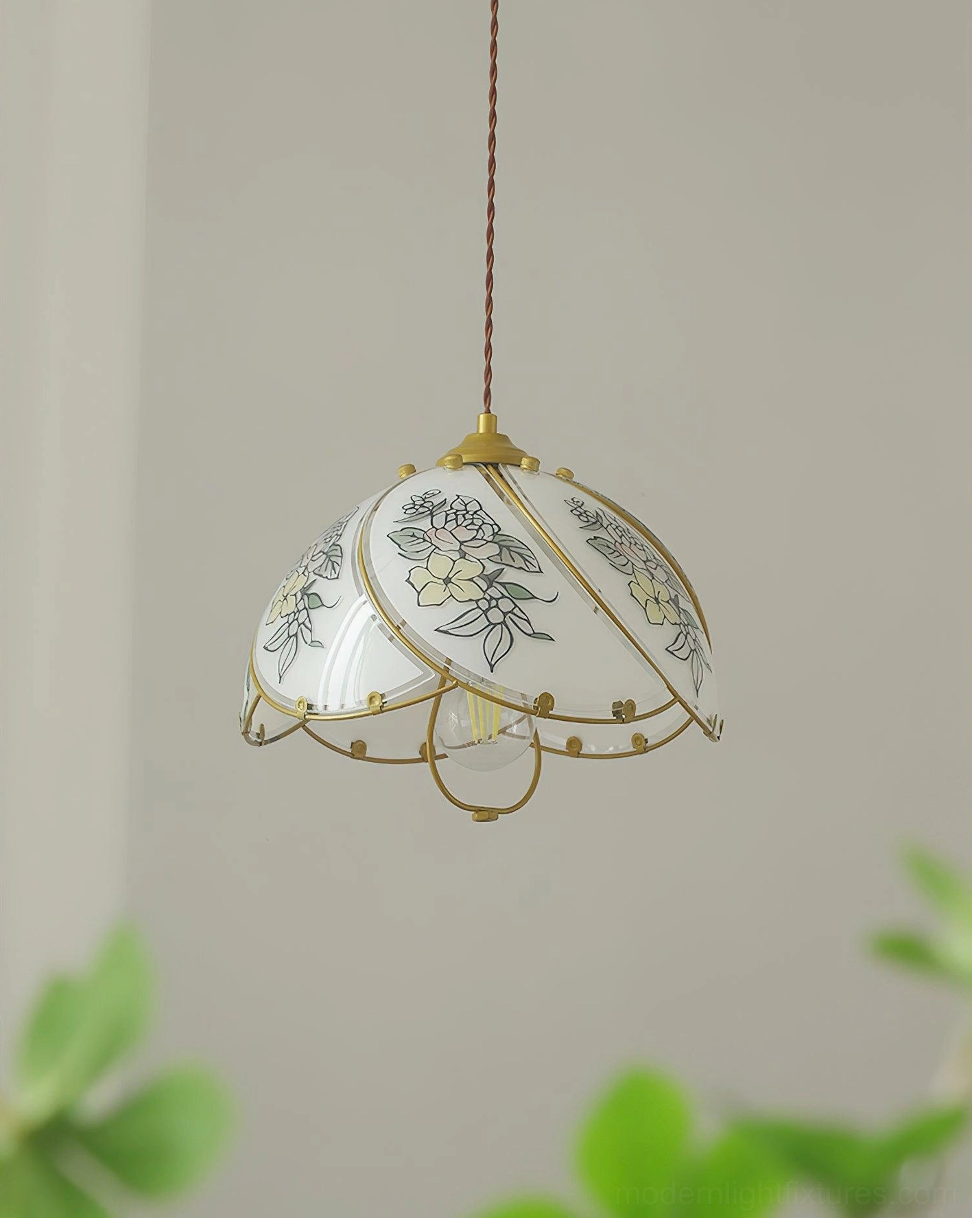 Handcrafted vintage lily pendant lamp with detailed gilded floral prints on opal milk glass, studio portrait