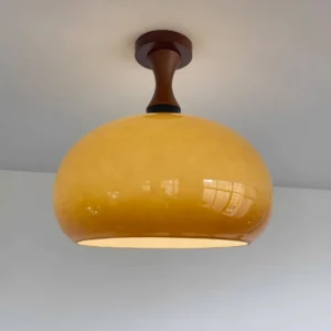 Three-quarter angle view of vintage Murano ceiling light showing polished amber dome shade and dark walnut fixture base