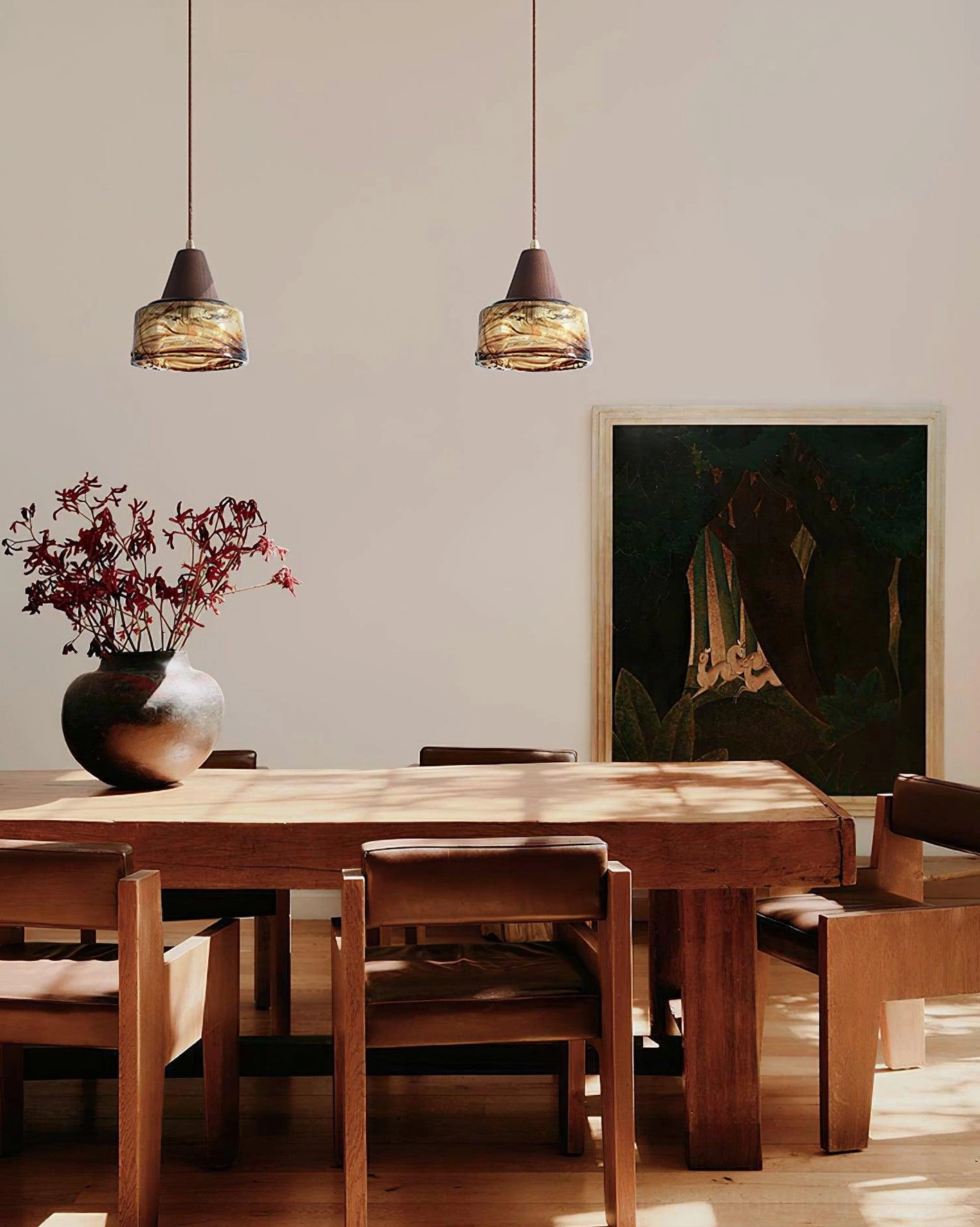 Pair of vintage Murano pendant lights in dining room with floral table centerpiece