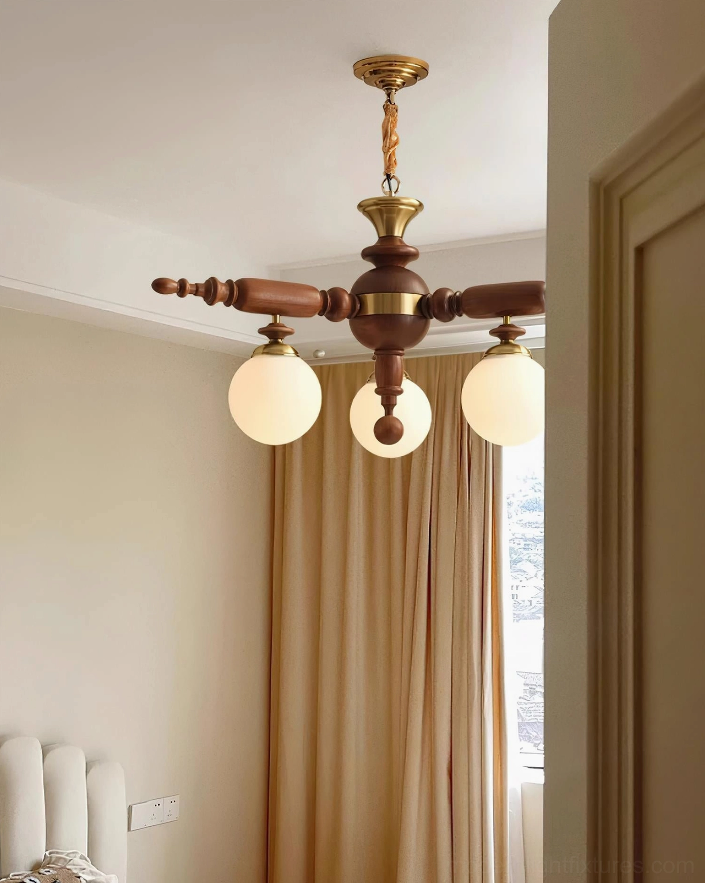 Side view of wooden Olina chandelier with brass accents and multiple lamp arms