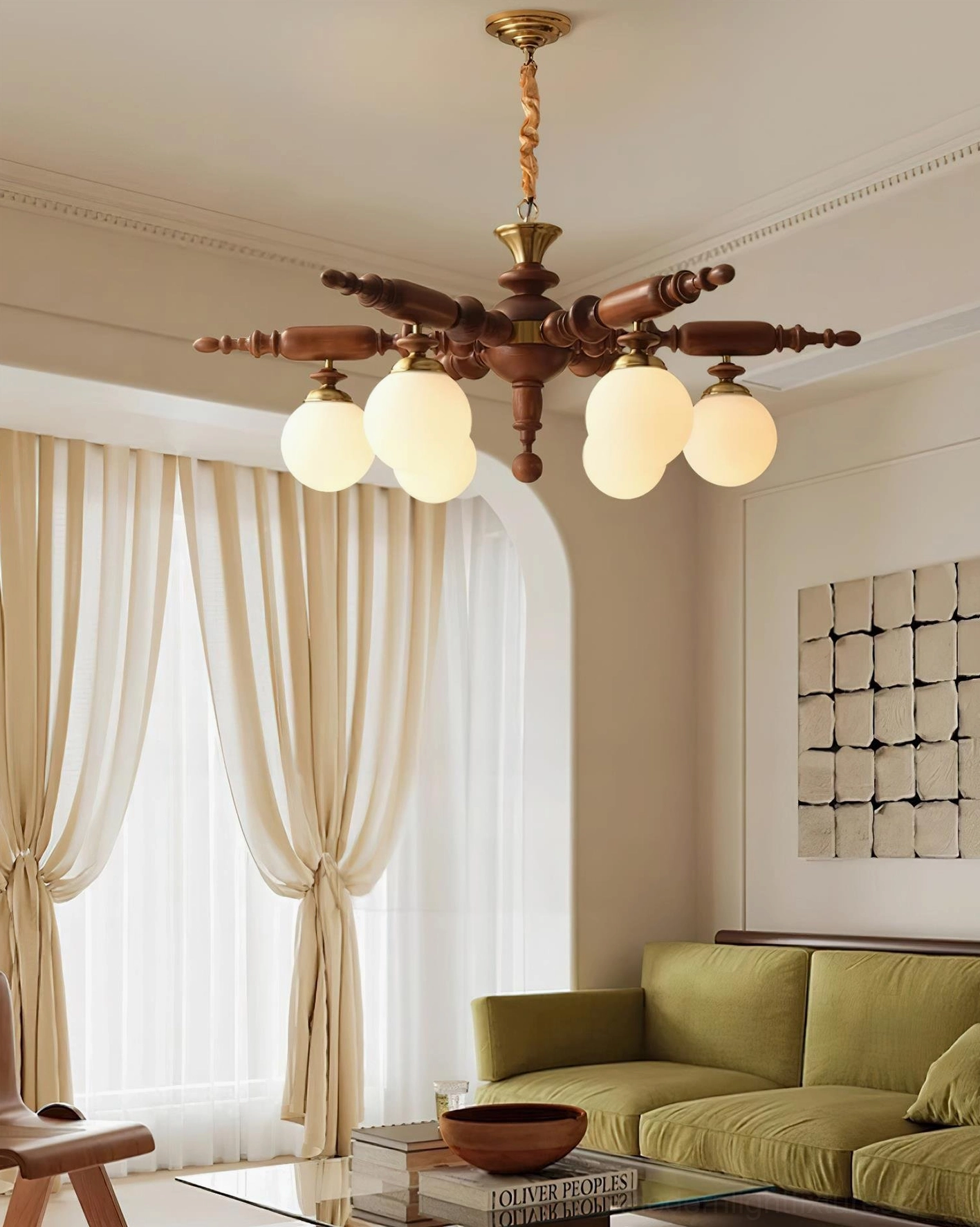 Dual-head wooden chandelier with frosted glass in French-style room with green sofa