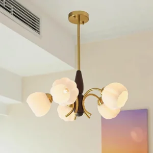 Orillia chandelier installed in living room showing warm brass hardware and frosted milk glass petal shades, low-angle perspective