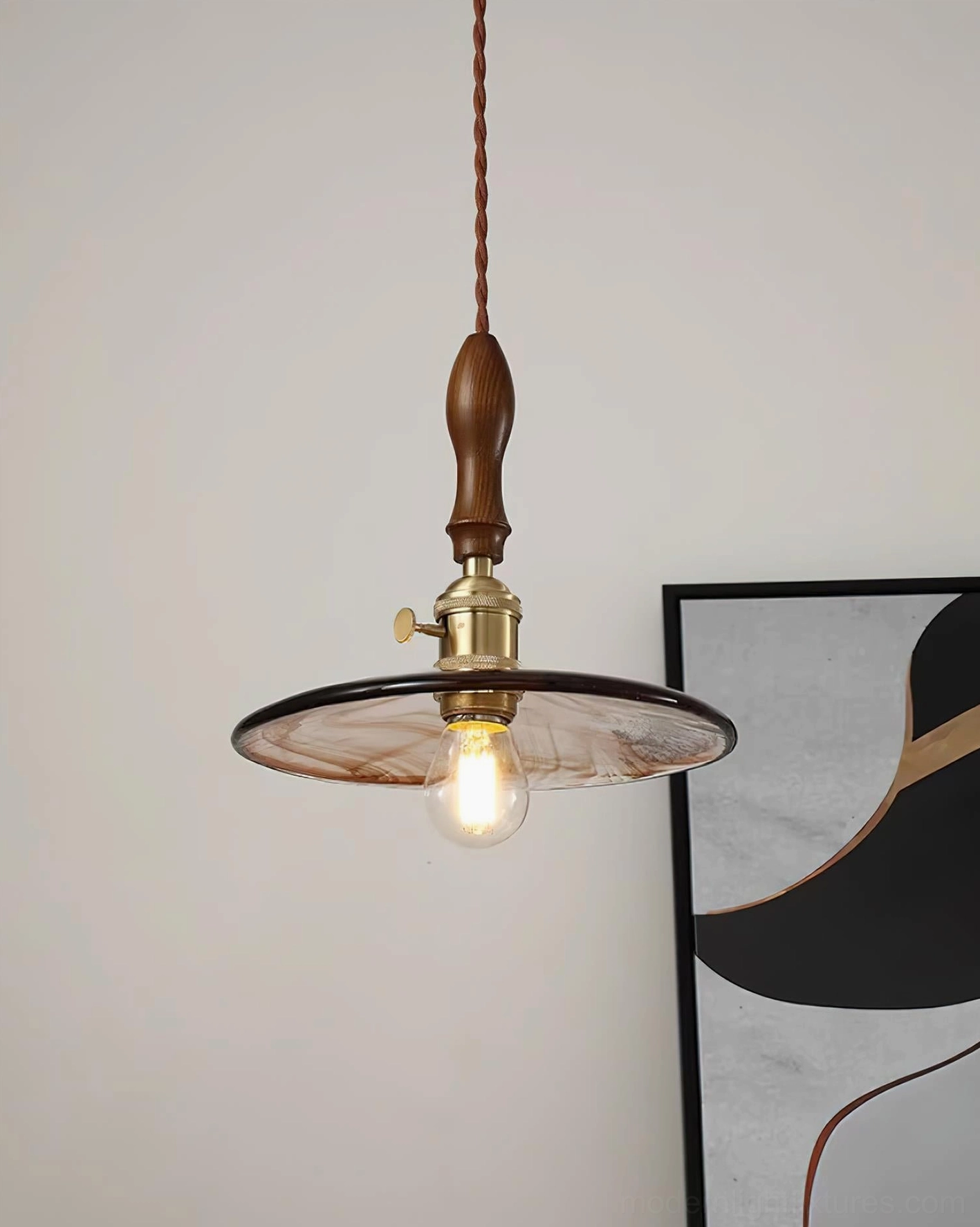 Vintage pendant ceiling light with saucer-shaped amber glass shade and brass socket detail