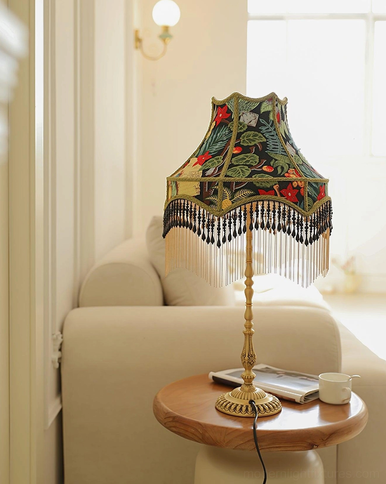 Vintage peony table lamp on wooden side table with books and cup beside beige sofa in living room