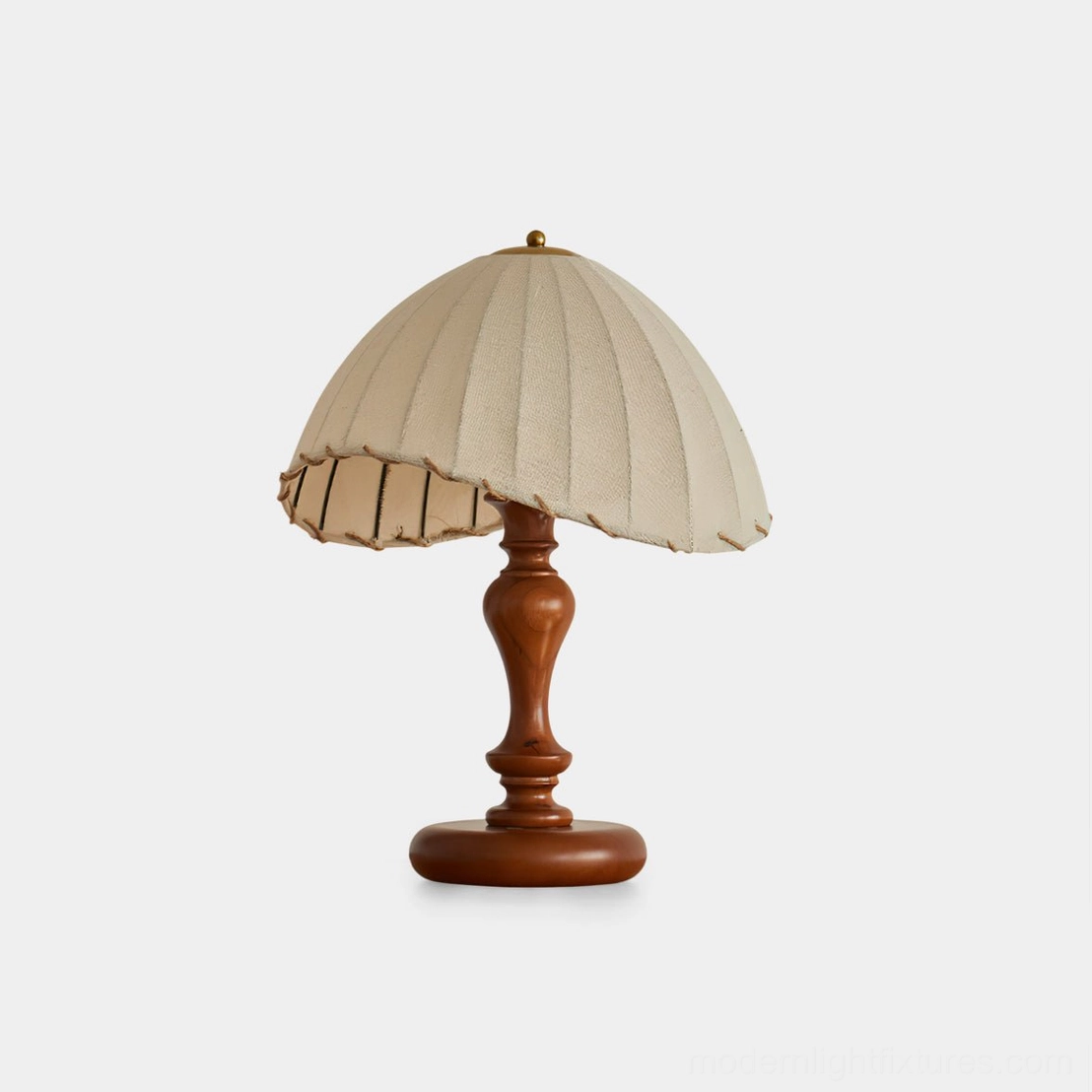 Vintage pleated linen table lamp with scalloped shade and walnut wood turned base, frontal view on white background