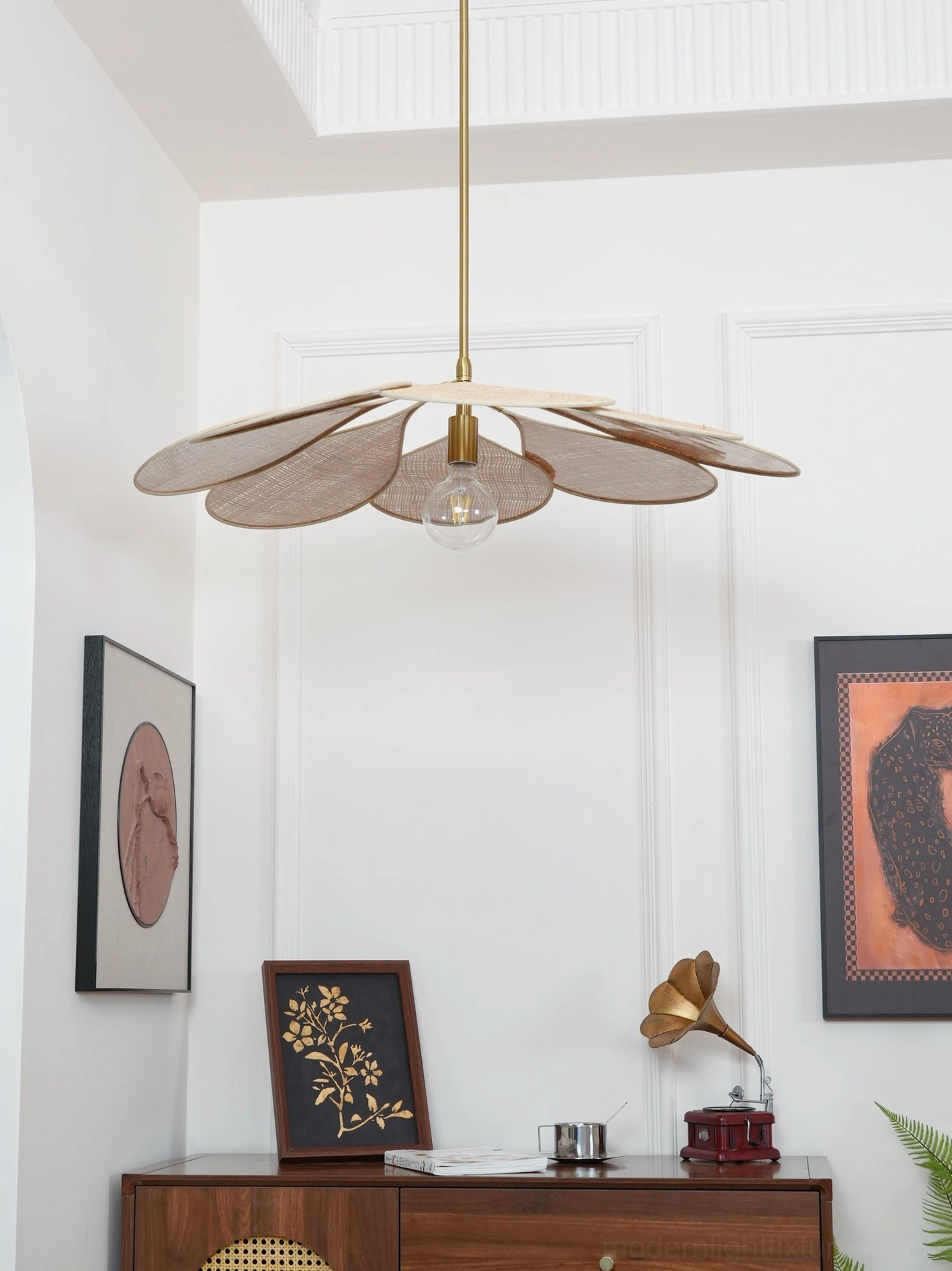 Vintage-inspired rattan pendant lamp in warm mid-century bohemian living room with decorative table