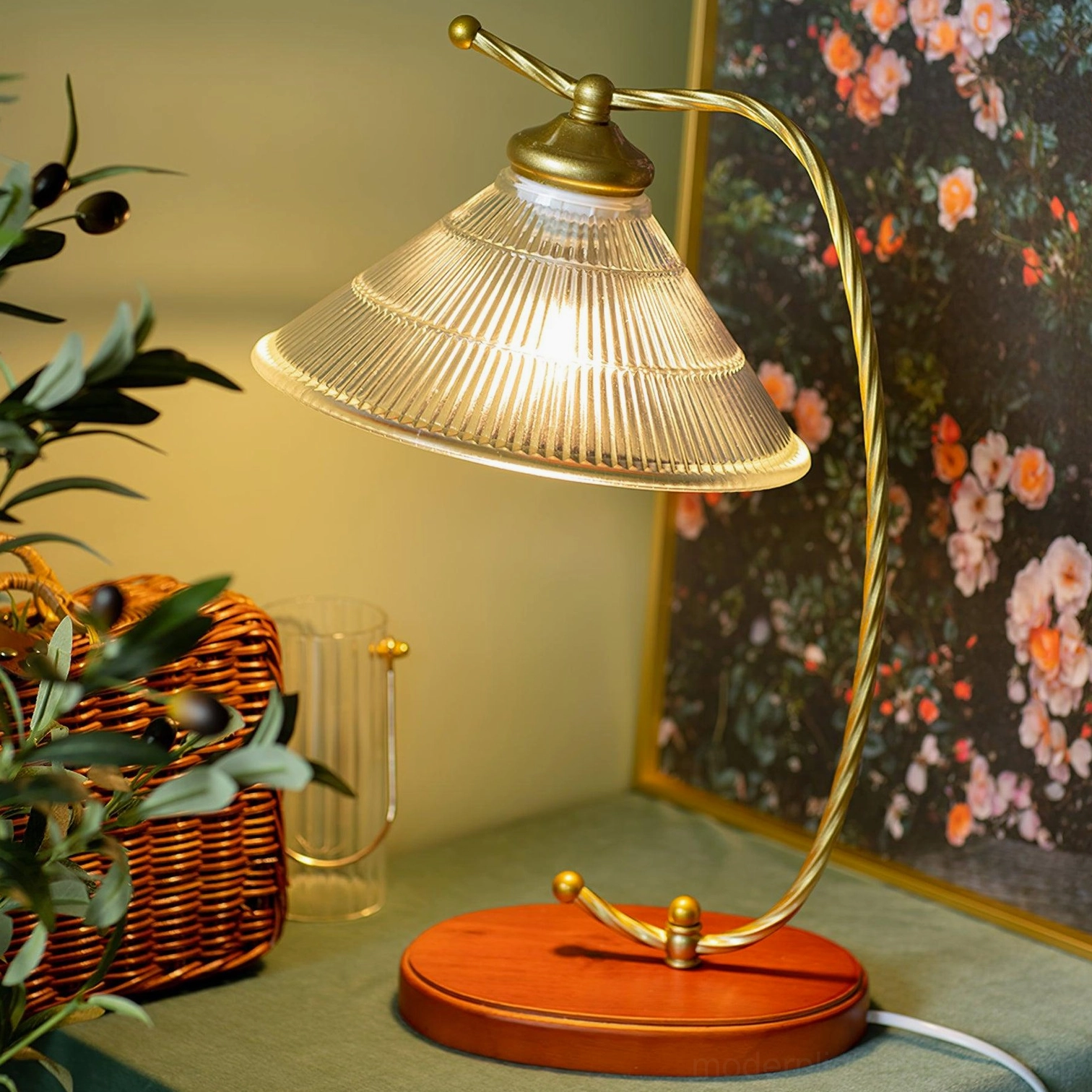 Retro arc table lamp lit in warm vintage home interior with wicker basket and floral wall decor, creating cozy ambient lighting