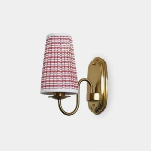 Vintage red and gold pleated fabric wall sconce with curved brass arm and scalloped backplate against white studio background