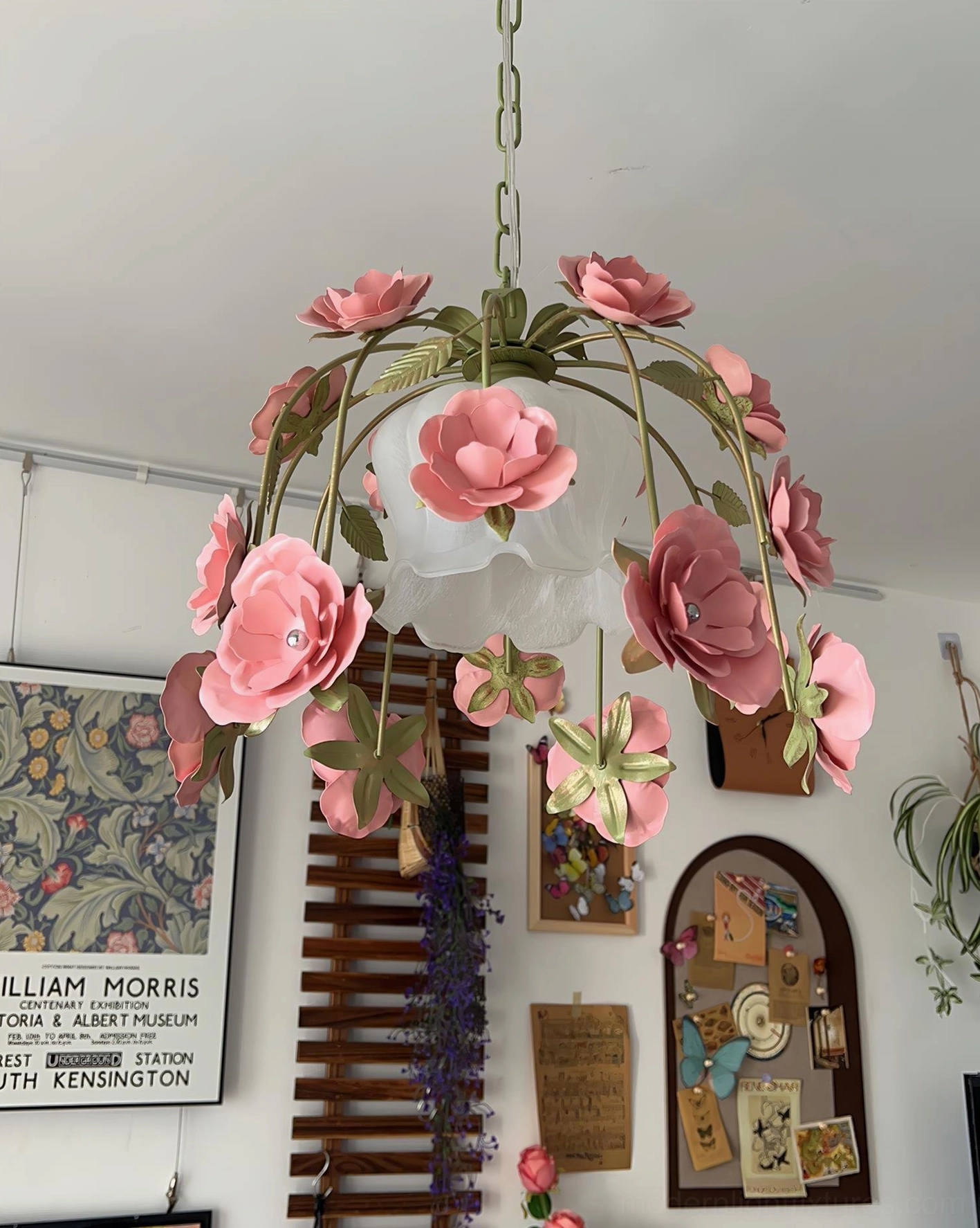 Vintage romantic rose pendant chandelier with pink gem-studded flowers and petal-shaped white lampshade, gallery wall interior