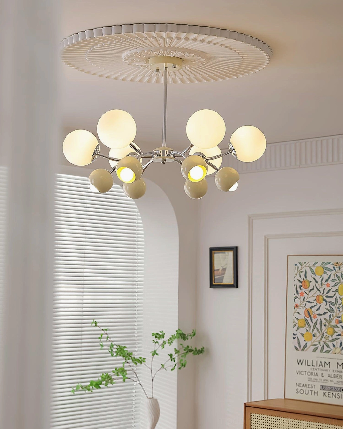 Vintage-inspired Sputnik chandelier with brass gold frame and frosted cream glass globe shades in French retro living room