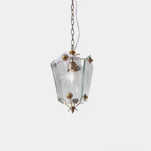 Vintage star-etched glass pendant light with brass metal frame overhead view studio photography