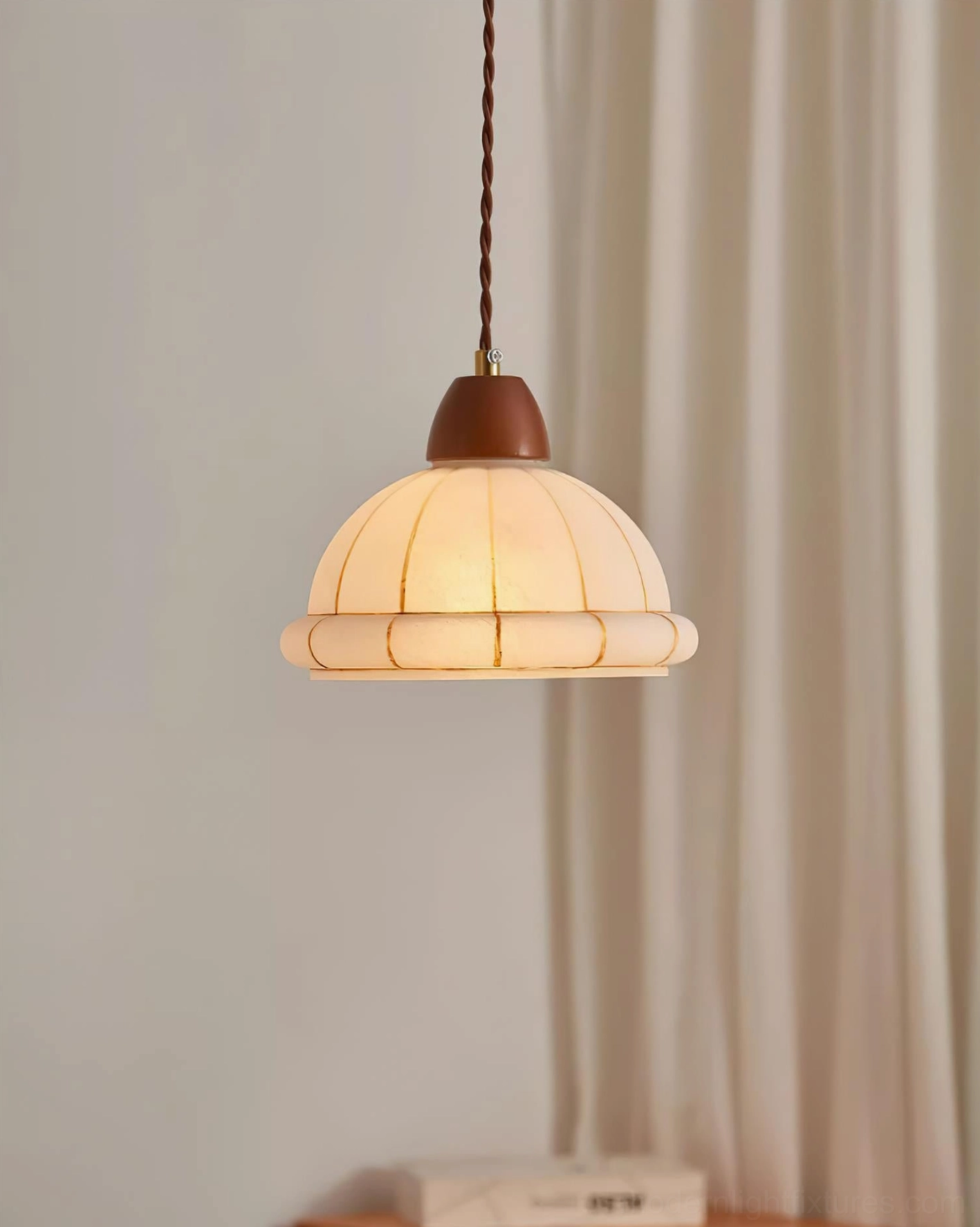 Mid-century modern pendant lamp with warm vintage style suspended in room interior with neutral tones