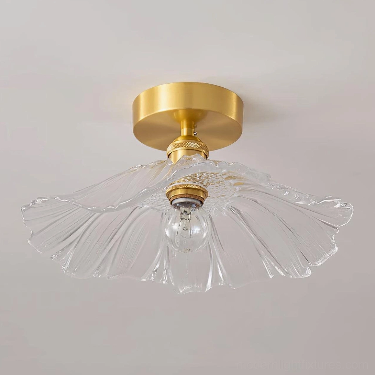 Vintage-style ruffled glass semi-flush ceiling light with transparent clear shade and polished brass hardware