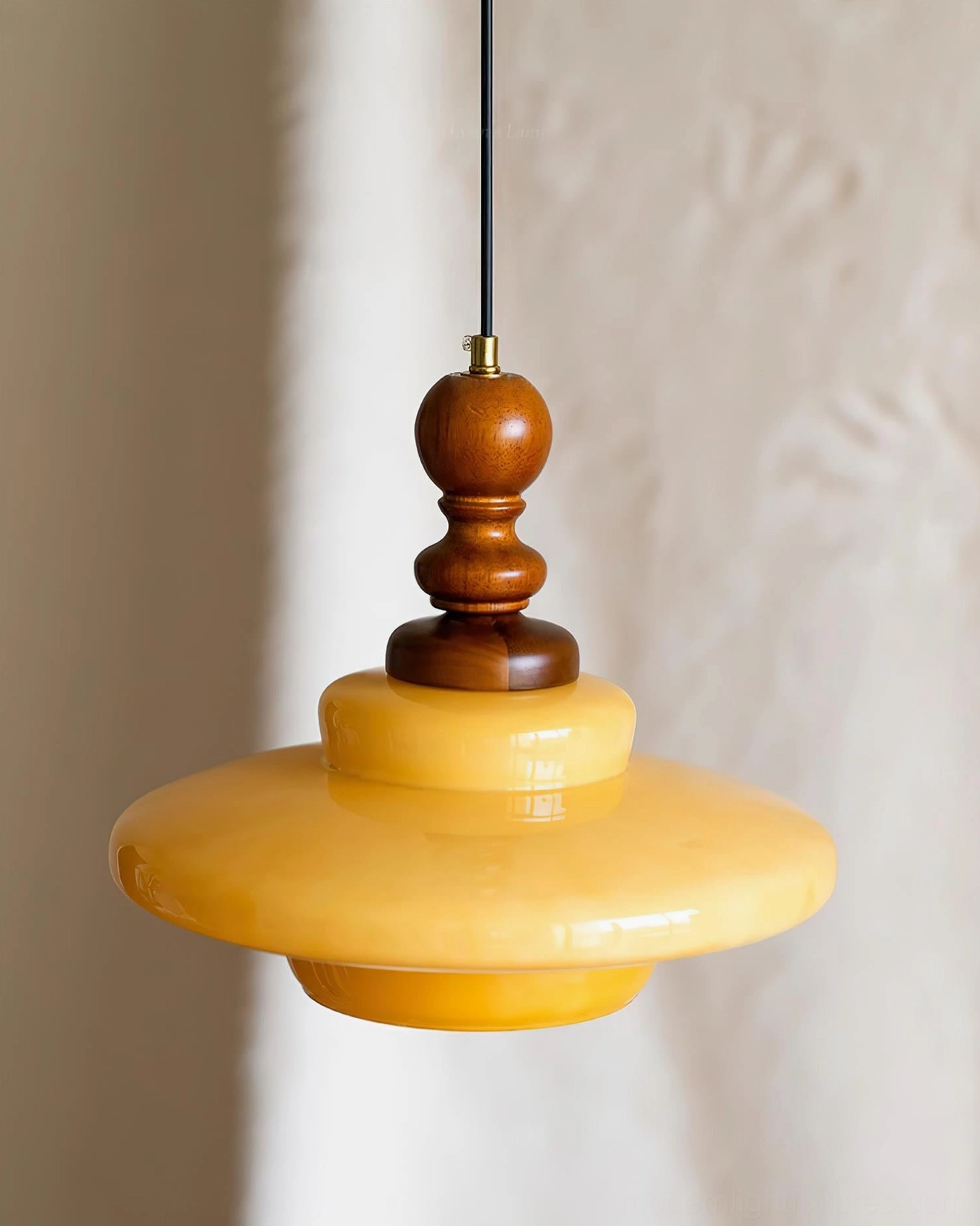 Mustard yellow glass pendant light fixture in modern home interior, showing warm color and mid-century design appeal