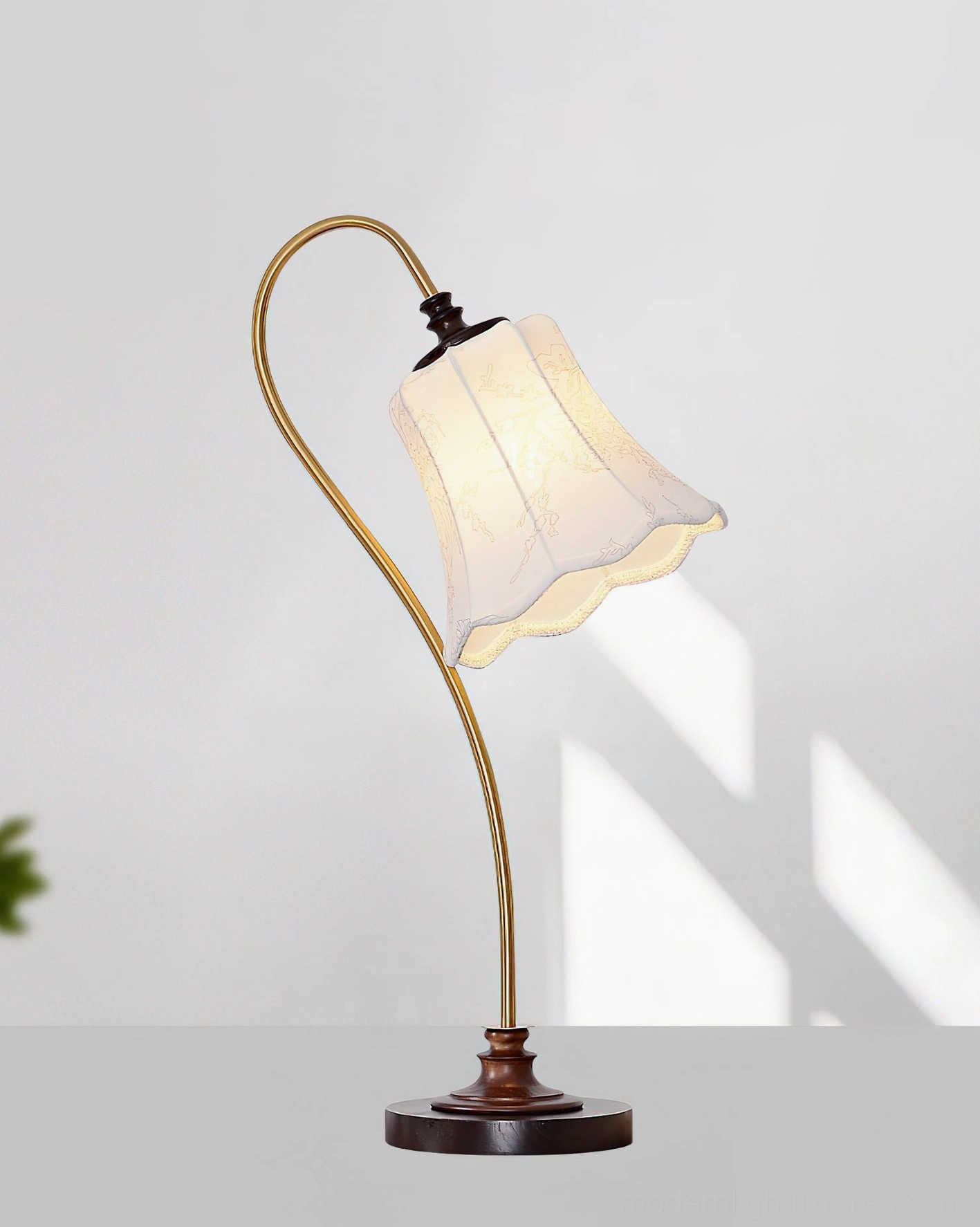 Vintage table lamp with embroidered lace shade and silver-toned metal arm - retro home setting