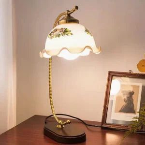 Illuminated retro table lamp on wooden bedside table creating warm ambient light with framed artwork