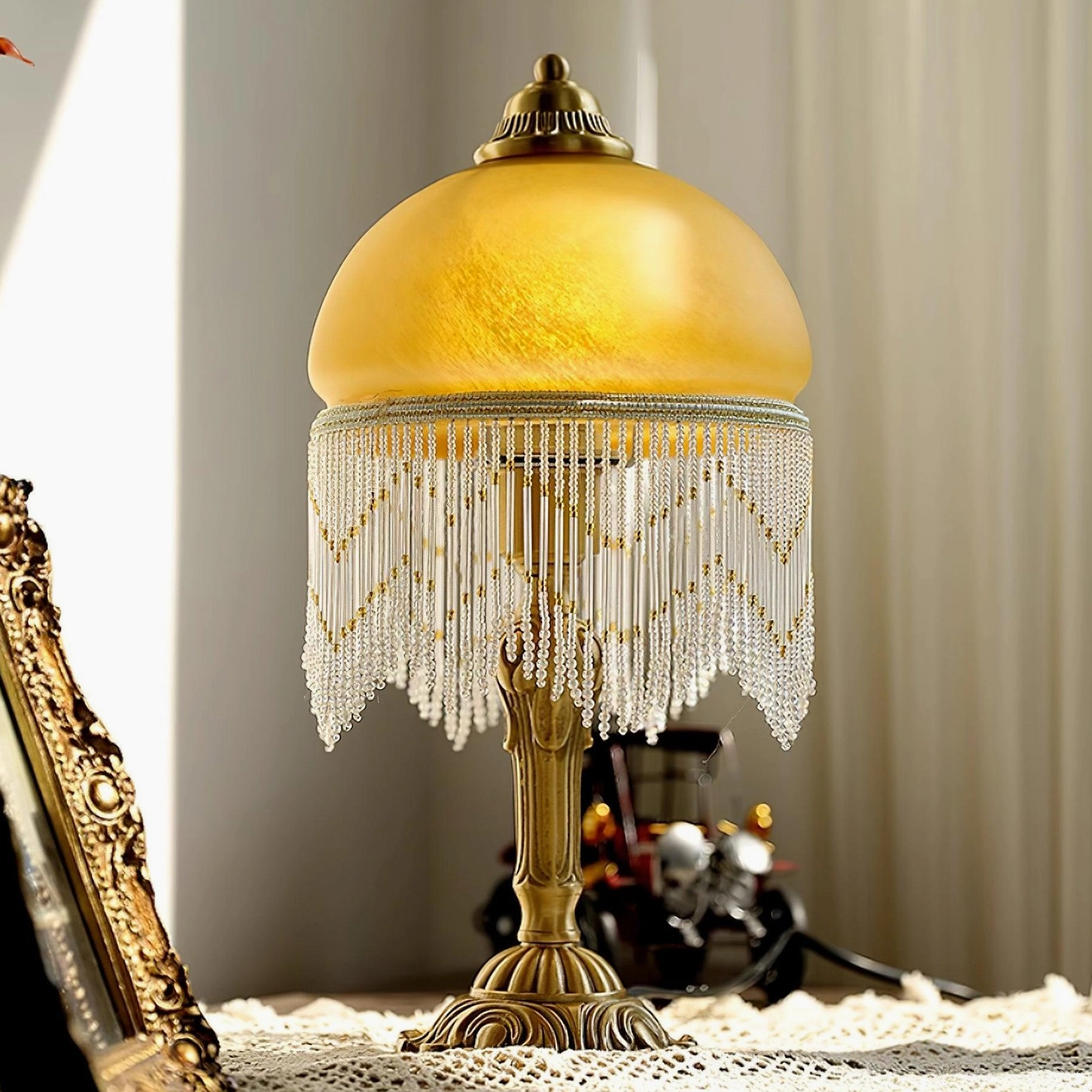 Vintage brass tassel table lamp left side view with lace tablecloth and antique home décor accessories