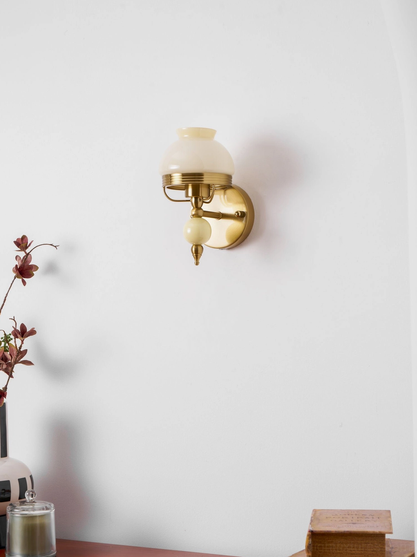 Vintage wall sconce architectural detail showing frosted glass shade and metal construction