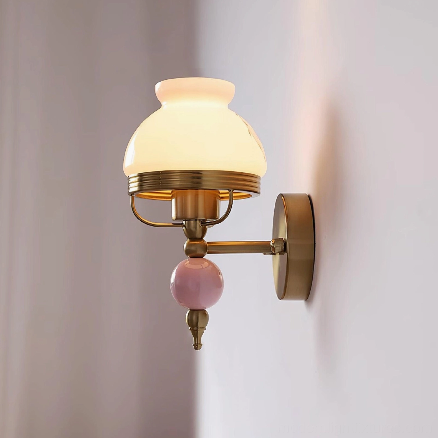 Lit retro wall sconce side profile on purple wall, warm glowing glass with brass hardware and ceramic accent