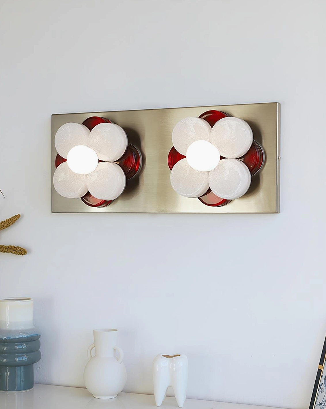 Violetta chrome and red glass wall sconce showcasing sculptural petal design with warm glowing light output