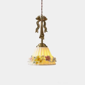 Vionna vintage floral pendant lamp with brass bow detail and embossed ceramic shade, studio front view