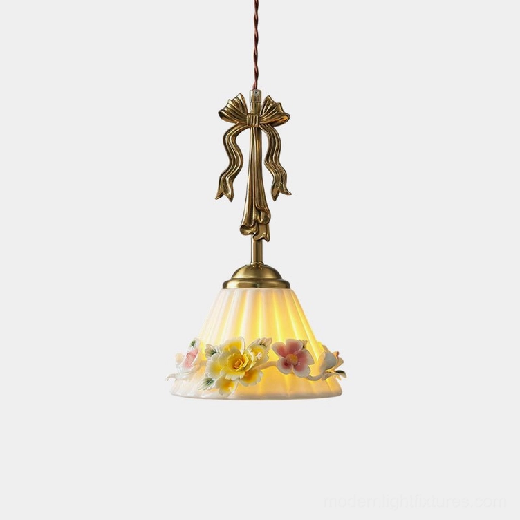 Vionna vintage floral pendant lamp with brass bow detail and embossed ceramic shade, studio front view