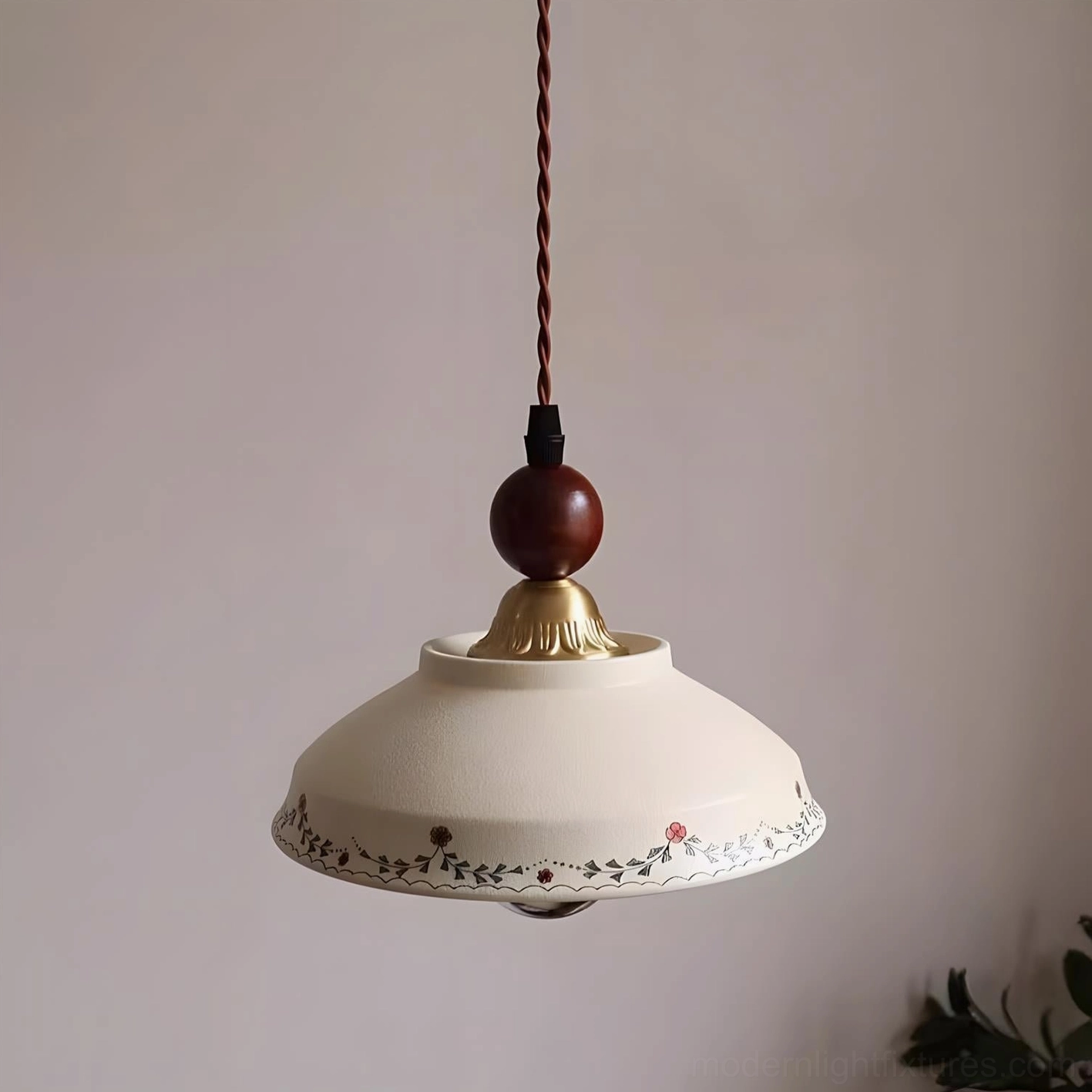Single Virella floral ceramic pendant with brass and walnut wood accents, close-up on pink wall background showing botanical details