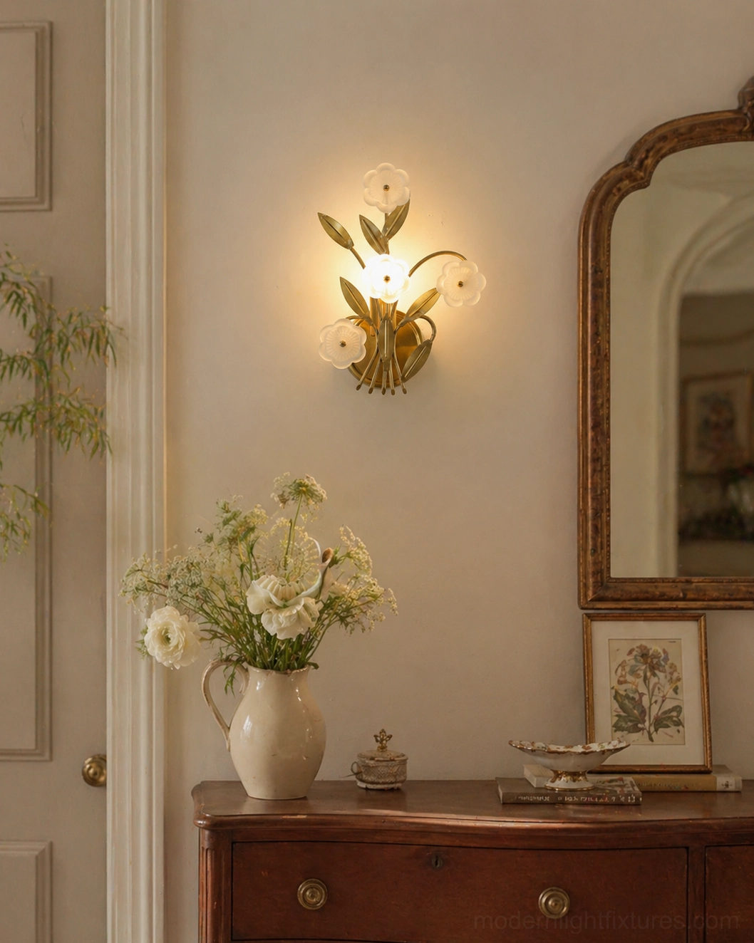 Virella wall sconce installed beside vintage vanity with wooden dresser and arched mirror in classic entryway