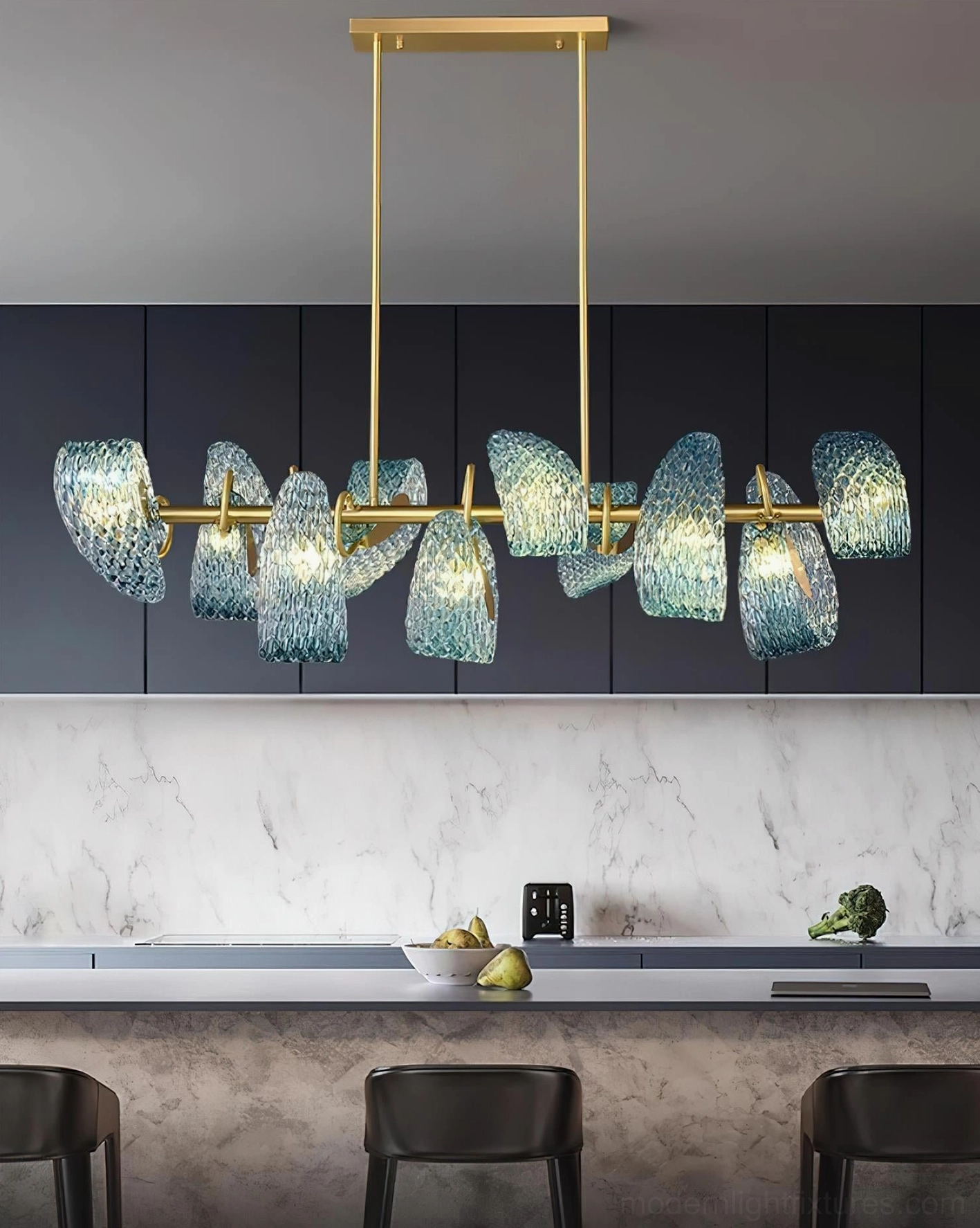 Virello linear pendant chandelier with brass gold frame and blue textured glass shades, modern kitchen island space